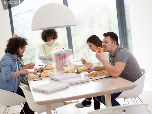 Image of multiethnic group of happy friends lunch time