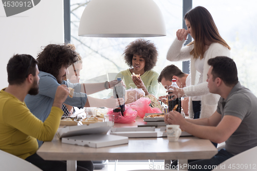 Image of multiethnic group of happy friends lunch time