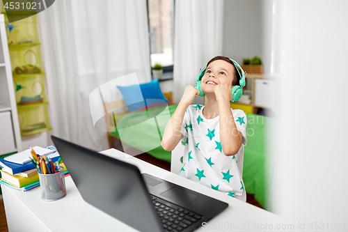 Image of boy celebrating victory in computer video game