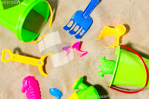 Image of close up of sand toys kit on summer beach