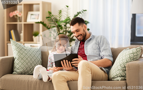 Image of father and daughter with tablet computer at home