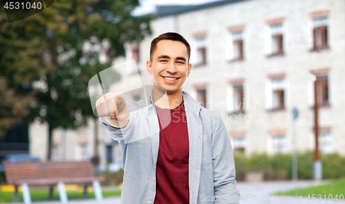 Image of man pointing finger to you over campus background