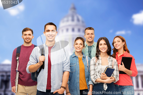 Image of group of students with books over white house