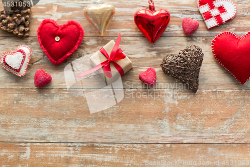 Image of christmas gift and heart shaped decorations