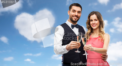 Image of happy couple with champagne glasses toasting