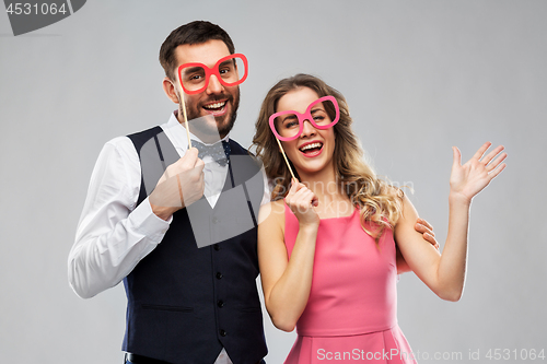 Image of couple with party props having fun and posing