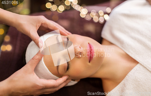 Image of woman having face and head massage at spa