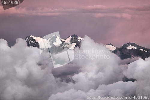 Image of Mountain peaks above moving clouds