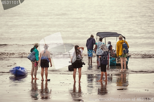 Image of Boarding a boat on the beach