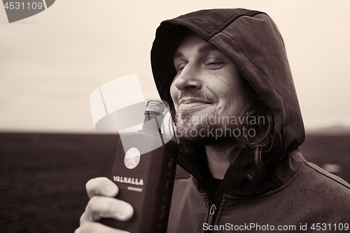 Image of Hooded man drinking in Iceland