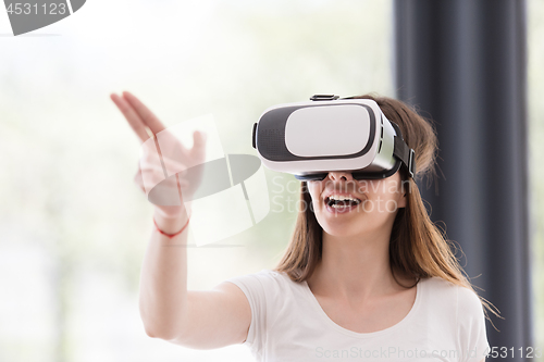 Image of woman using VR-headset glasses of virtual reality