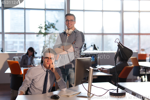 Image of Two Business People Working With computer in office