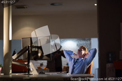 Image of businessman relaxing at the desk