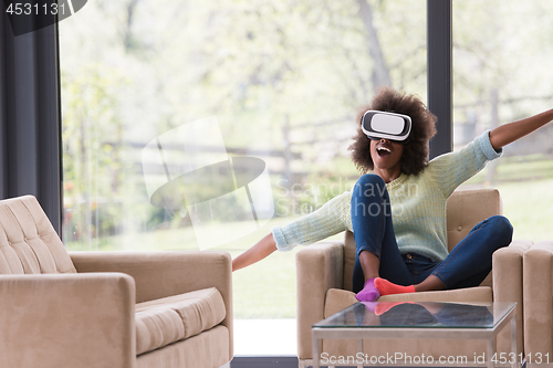 Image of black woman using VR headset glasses of virtual reality