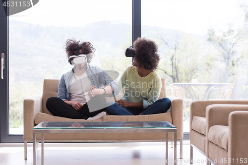 Image of Multiethnic Couple using virtual reality headset