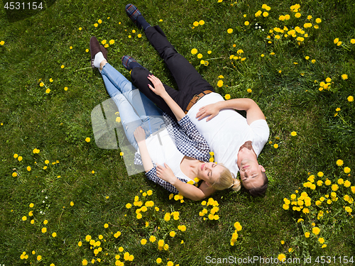 Image of man and woman lying on the grass