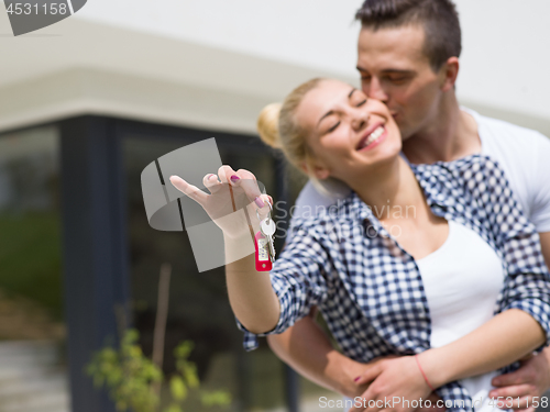 Image of couple hugging in front of  new luxury home