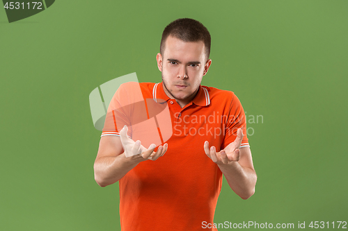 Image of The young emotional angry and scared man standing and looking at camera