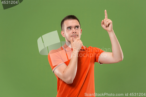 Image of Young serious thoughtful businessman. Doubt concept.