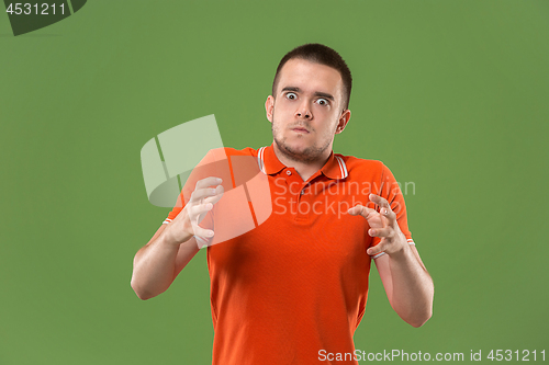 Image of The young emotional angry and scared man standing and looking at camera