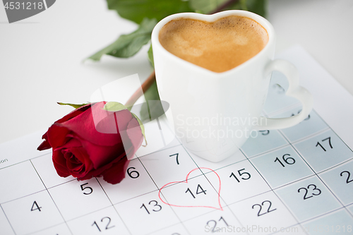 Image of close up of calendar, heart, coffee and red rose