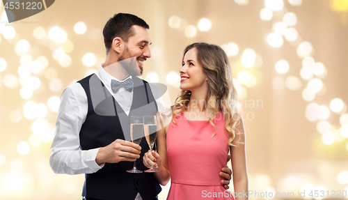 Image of happy couple with champagne glasses toasting