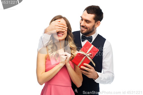 Image of happy man giving woman surprise present