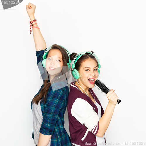 Image of teenage girls in earphones listening to music