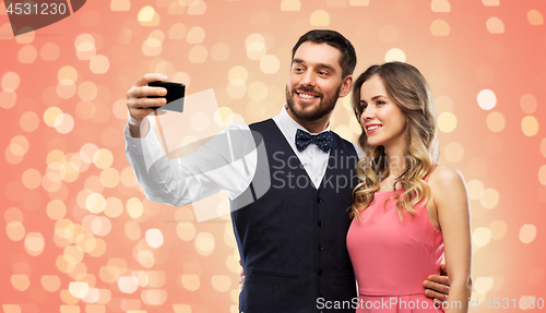 Image of happy couple taking selfie by smartphone