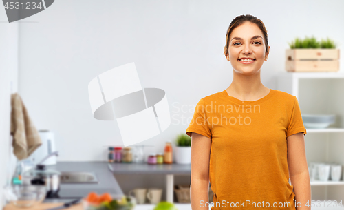 Image of teenage girl in orange t-shirt over kitchen