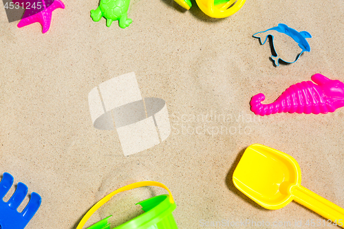 Image of close up of sand toys kit on summer beach