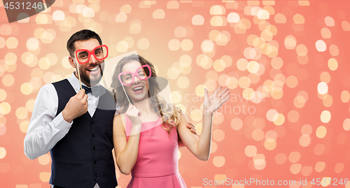 Image of couple with party props having fun and posing