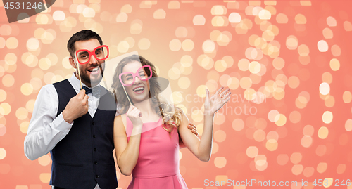 Image of couple with party props having fun and posing