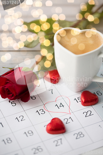 Image of close up of calendar, hearts, coffee and red rose