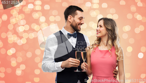 Image of happy couple with champagne glasses toasting