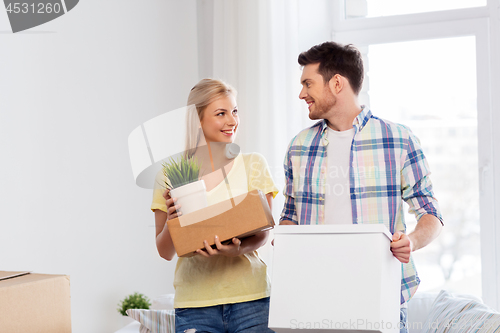 Image of happy couple with boxes moving to new home