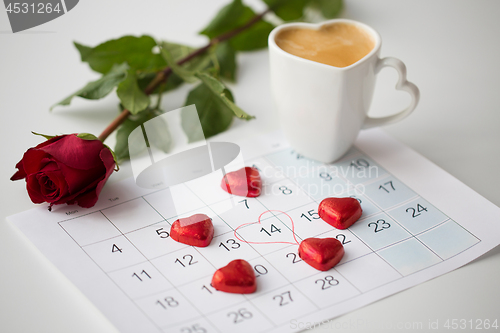 Image of close up of calendar, hearts, coffee and red rose