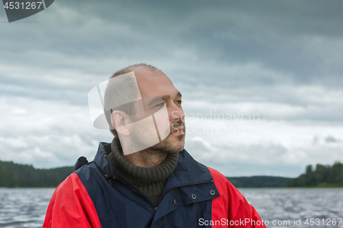 Image of Conceptual Portrait Of A Pensive Bearded Man Against A Overcast 