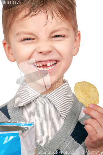 Image of Little boy is eating chips