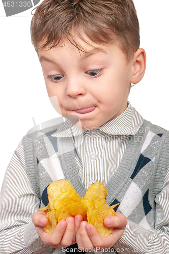 Image of Little boy is eating chips