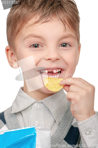 Image of Little boy is eating chips