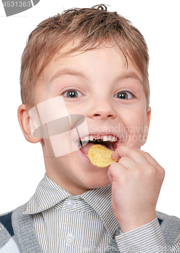 Image of Little boy is eating chips