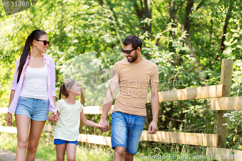 Image of happy family walking in summer park