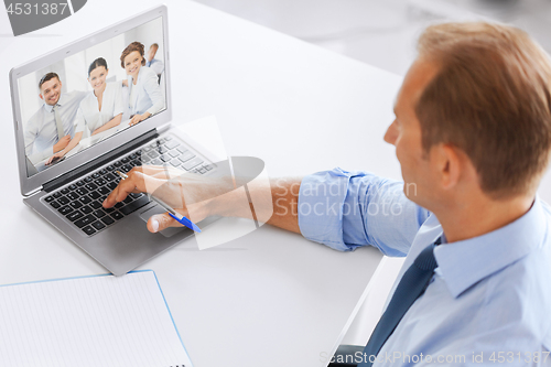 Image of businessman having video conference at office