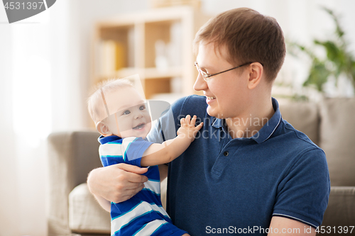 Image of happy baby boy with father at home