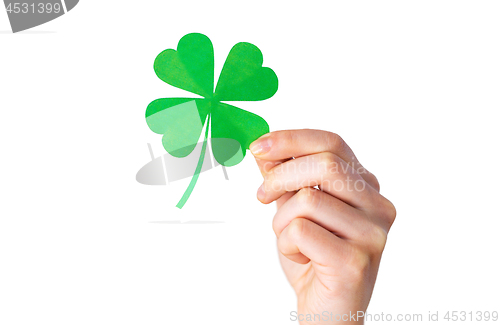 Image of hand holding green paper four-leaf clover