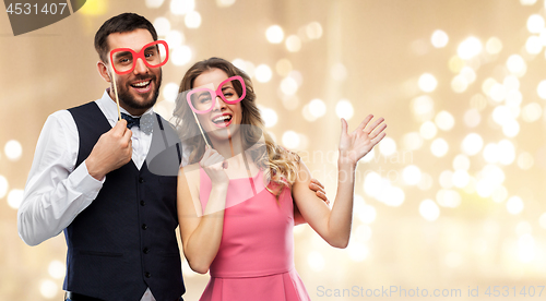 Image of couple with party props having fun and posing