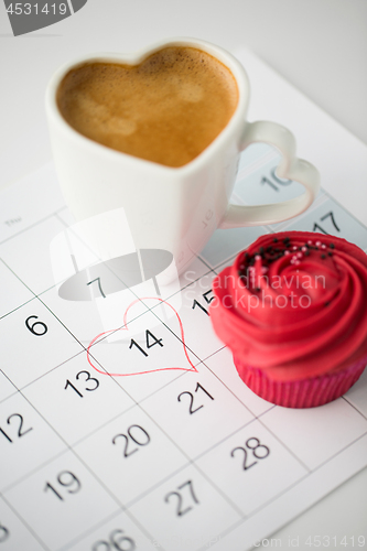 Image of close up of calendar, coffee, cupcake and heart