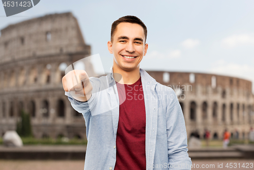 Image of man pointing to you over coliseum background