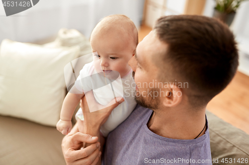 Image of close up of father with little baby girl at home